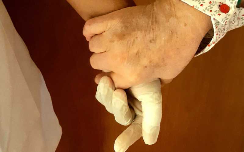 Résidente tenant la main de l'aide-soignante