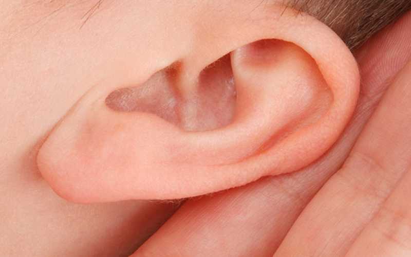 une main proche d'une oreille